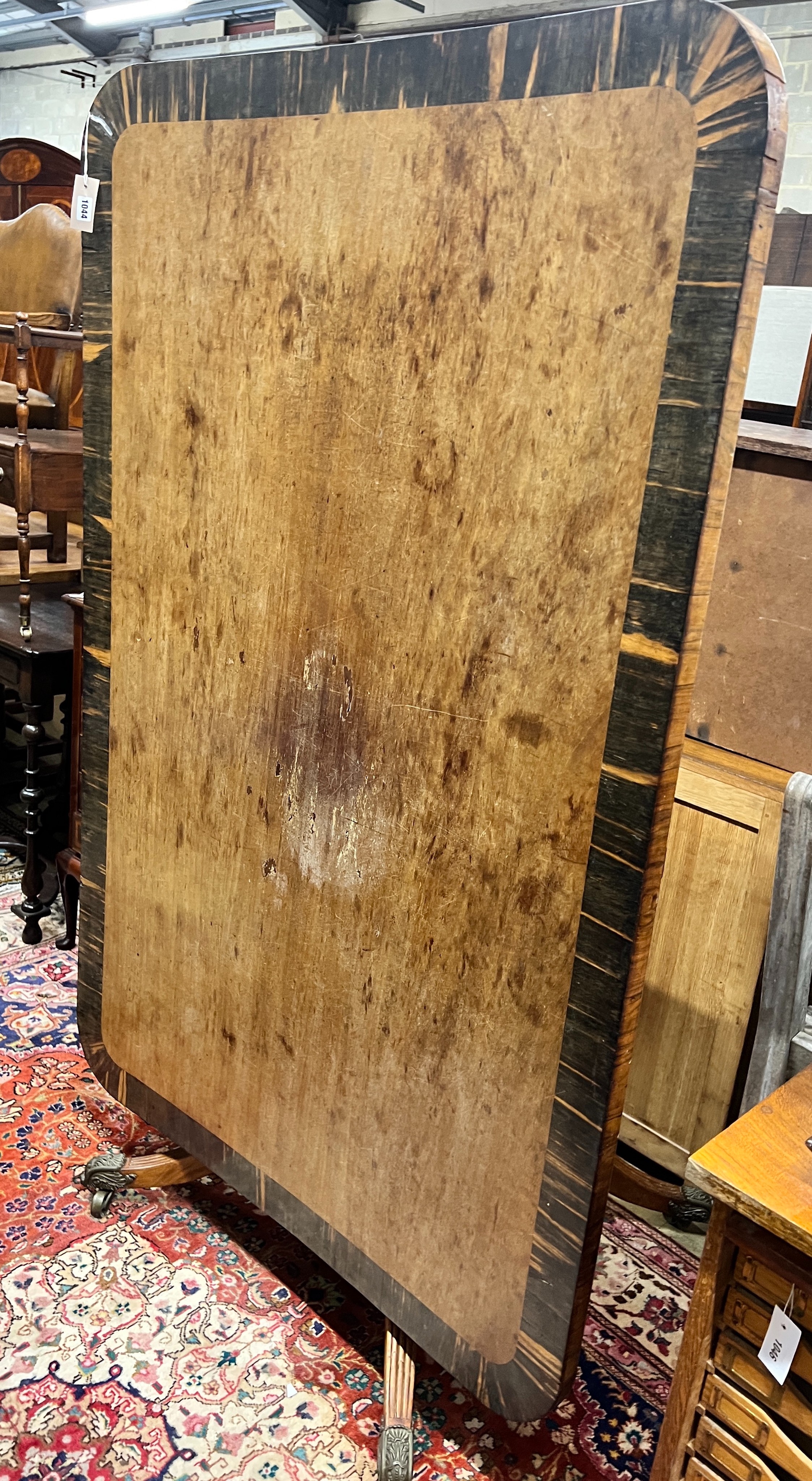 A Regency coromandel banded rectangular mahogany tilt top dining table, length 160cm, width 106cm, height 74cm